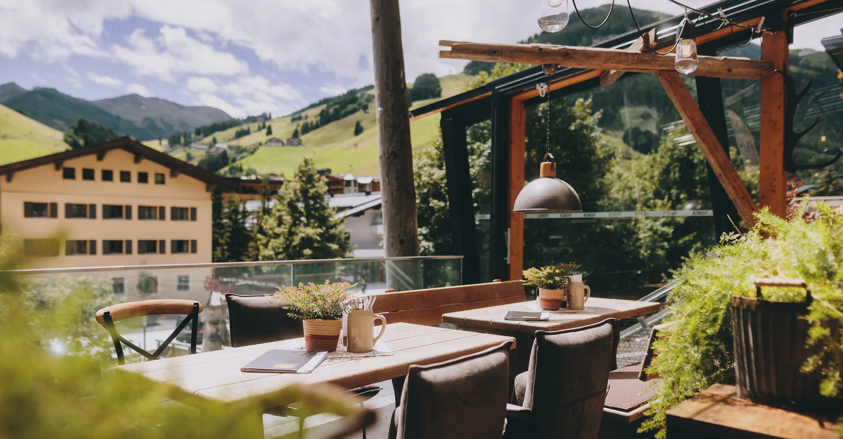 Gemütlicher Außenbereich eines Restaurants mit Blick auf die Berge